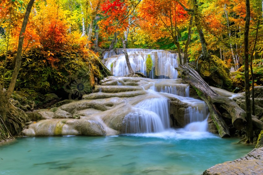 Colorful majestic waterfall in national park forest during autum